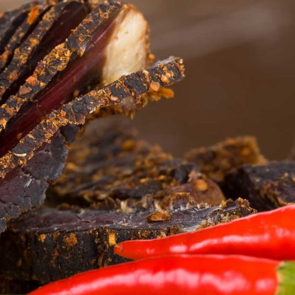 sliced dry biltong with chilli flakes and seasoning