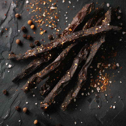 photo from above of biltong stokkies in bbq smoked flavour, sticks made of beef biltong in rustic luxury photo